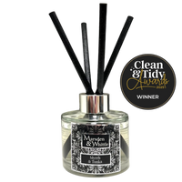 Marsden & Whittle reed diffuser - a glass bottle with 4 black reeds and Clean & Tidy Awards badge