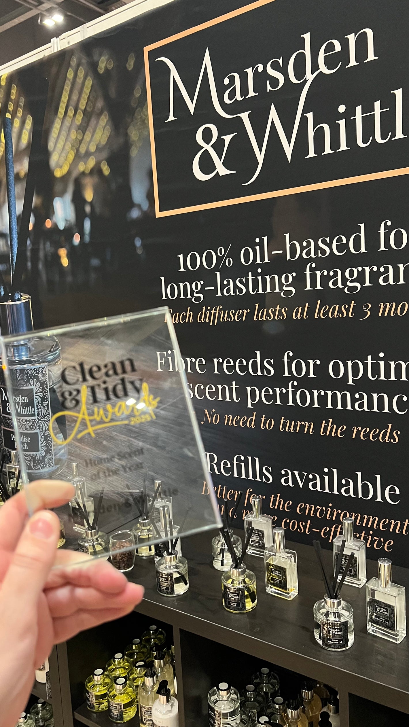 A close-up of the Clean & Tidy Award trophy for Home Scent of the Year on the Marsden & Whittle stand at the Home, Life & You event at Excel London in October 2025.
