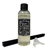 Amber & Sweet Orange Reed Diffuser Refill with 4 black reeds and a small plastic funnel