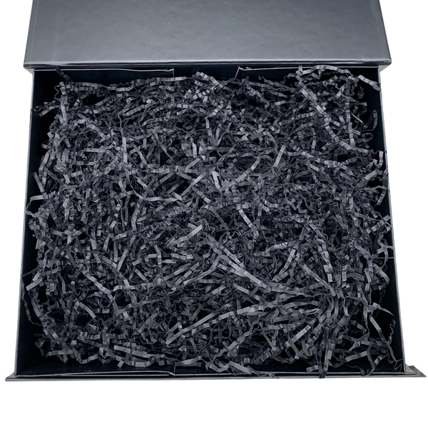 Black shredded paper in a black box on a white background