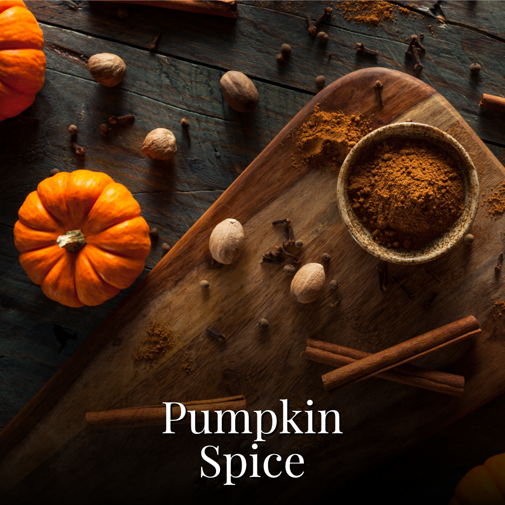 Pumpkin spice blend in a small ceramic bowl on a wooden cutting board, surrounded by cinnamon sticks, whole spices, nutmegs, cloves, and small pumpkins on a dark rustic wooden table. The text 'Pumpkin Spice' is overlaid at the bottom.