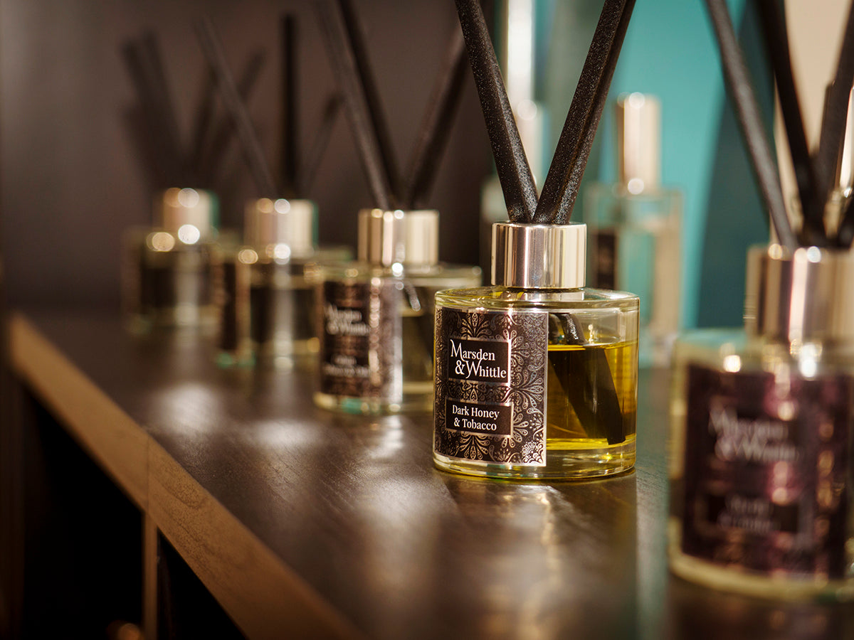A set of Marsden & Whittle Reed Diffusers on a black shelf inside the Wrexham Fragrance Shop at Chapter Court