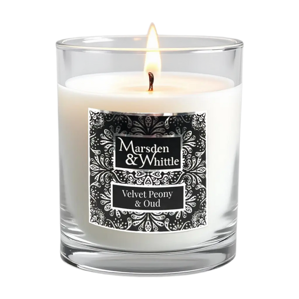 Velvet Peony & Oud Candle in a clear glass jar